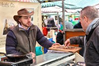 Customer sampling food at the Knaresborough Christmas Market by Charlotte Gale Photography